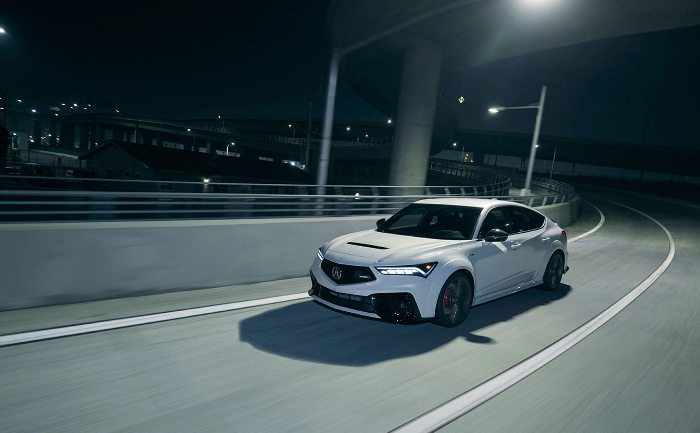 grey white sports car 2024 acura integra speeding in city night highway