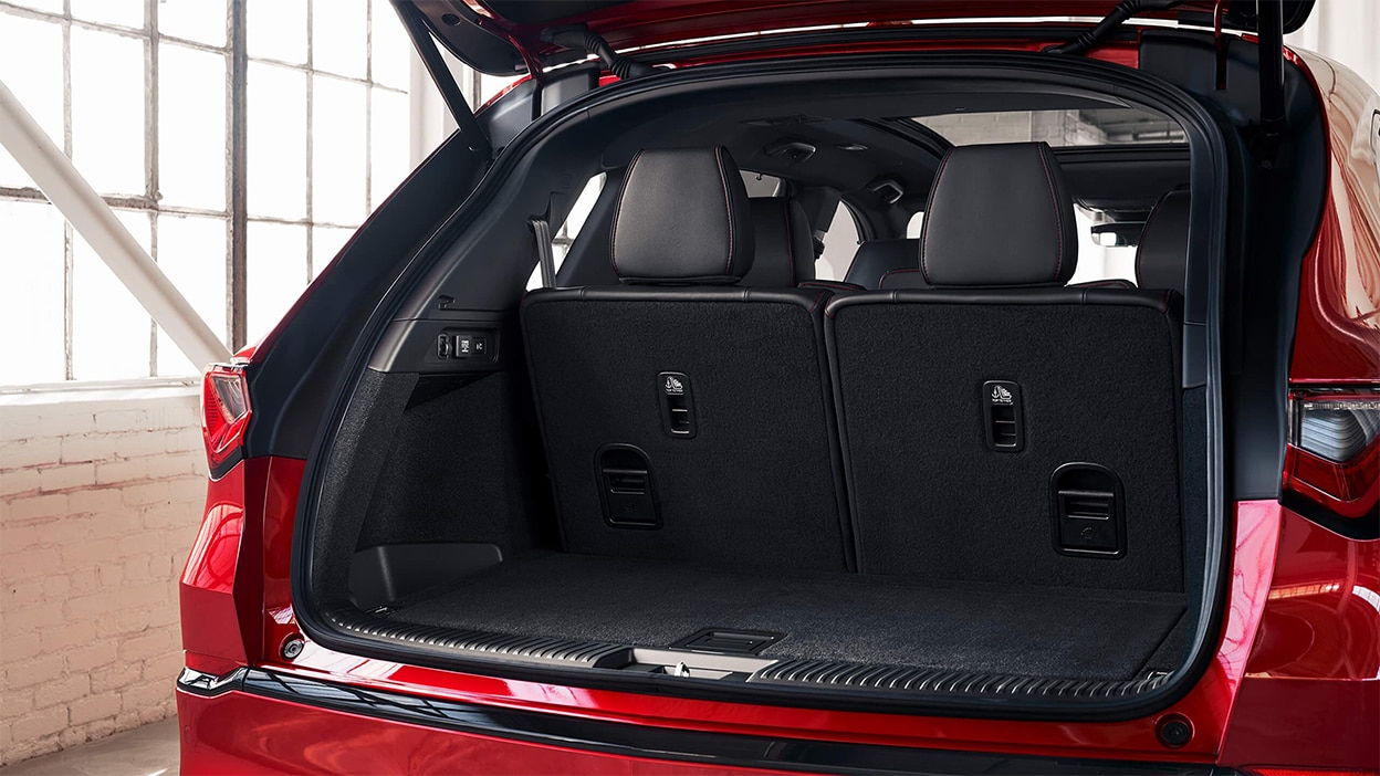 2024 red Acura MDX trunk with plenty of space, with the option to lower the seats for even more trunk space.